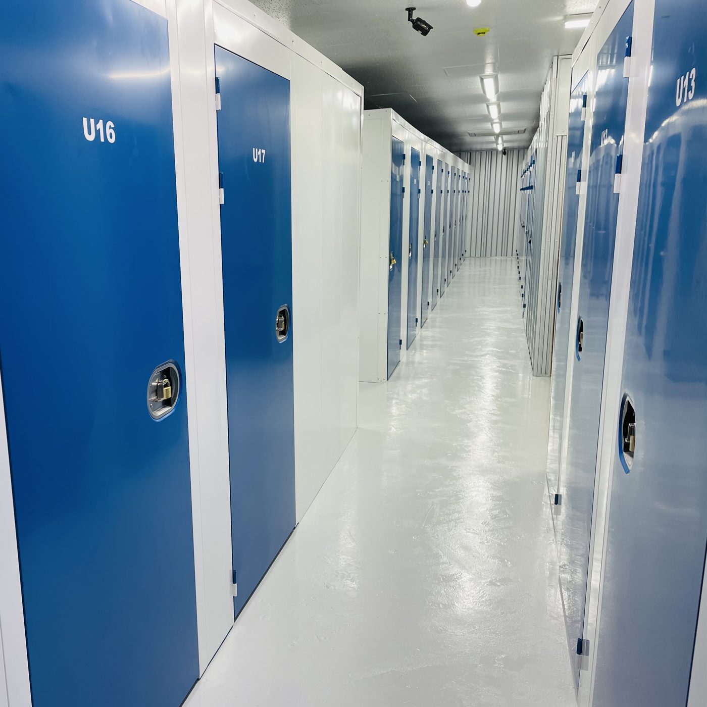 Indoor climate-controlled storage hallway with blue doors